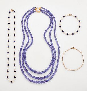 A TANZANITE BEAD NECKLACE, three strands of graduated faceted tanzanite bea