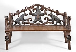 An early 20th century Black Forest bear carved linden arm chair and bench