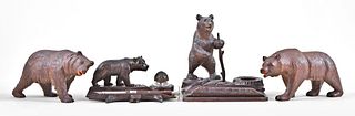 Lot of four carved Black Forest bear shelf and desk items