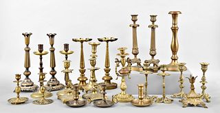 A lot of brass candlesticks and two oil lamps