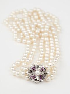 A triple-strand cultured pearl and ruby necklace