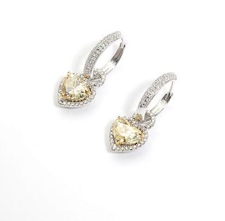 A pair of colored diamond heart-shaped earrings