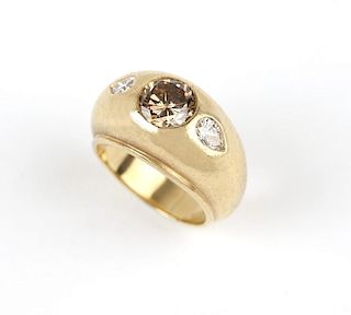 A colored diamond and gold ring