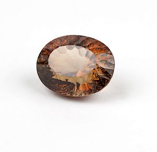 An unmounted orangy brown oval topaz