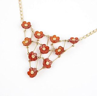 A gold and floral carved carnelian bib necklace
