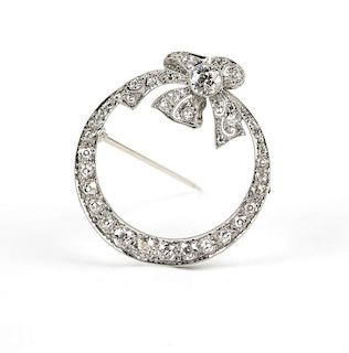 An Art Deco diamond and platinum circle brooch