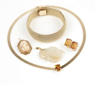 A collection of stone and gold jewelry