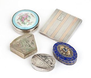 A group of four pill boxes and one match case