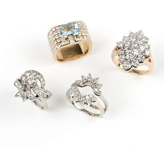 A group of four diamond and gold rings
