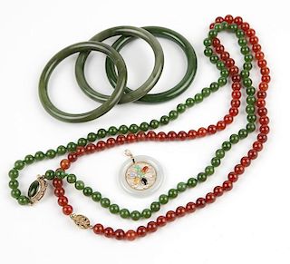 A collection of jade and stone jewelry