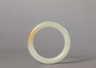 A Carved White and Russet Jade Bangle