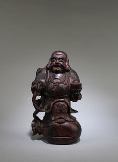A Carved Wooden Smiling Buddha Statue