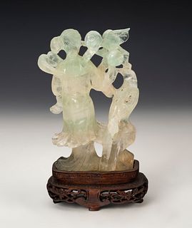 Figure of fairy with bird. China, 20th century. 
Jade carved by hand on wooden base.