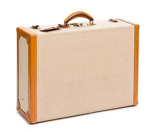 * An Hermes Leather Banded Canvas Suitcase, 21.5" x 15" x 7".