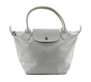 A Longchamp White Leather Le Pliage Mini Handbag, 13.25" x 9.5" x 1.5".
