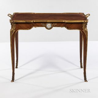 Louis XV-style Mahogany-veneered Ormolu-mounted Tray Table, early 20th century, shaped top bound with metal edge and integrated handles, frieze decora