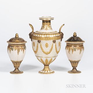 Three Wedgwood Gilded and Bronzed Queensware Vases, England, c. 1885, single with upturned loop handles, floral festoons terminating at ram's heads, h