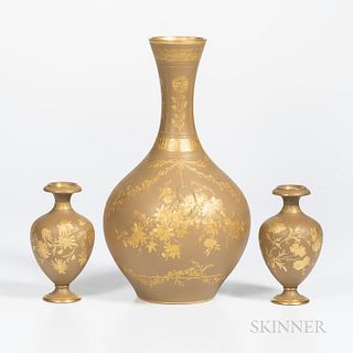 Three Wedgwood Gilded Drab Ground Earthenware Vases, England, c. 1885, each with floral decoration, a pair, ht. 5 1/2; and a bottle shape, ht. 12 1/4 