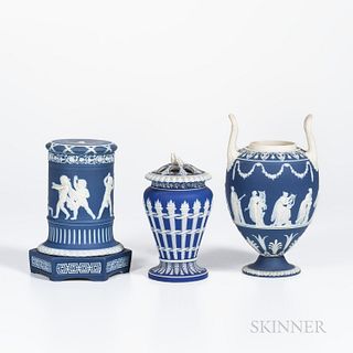 Three Wedgwood Dark Blue Jasper Dip Items, England, 19th and early 20th century, each with applied white relief, a torches vase and cover, ht. 7 1/8; 