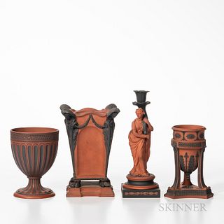 Four Wedgwood Rosso Antico Items, England, 19th century, each with applied black basalt relief, a tripod base incense burner, ht. 6 3/4; figural candl
