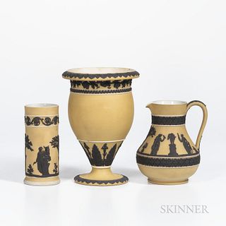 Three Wedgwood Yellow Jasper Dip Items, England, c. 1930, each with applied black jasper relief, two with classical figures, an etruscan jug, ht. 5 7/
