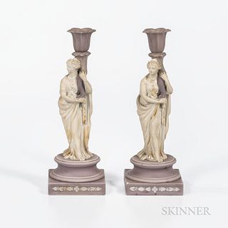 Two Wedgwood Lilac and White Jasper Candlesticks, England, 19th century, each with a maiden holding a cornucopia-shaped candle arm and standing on a r