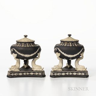Two Wedgwood Black Jasper Dip Dolphin Incense Burners, England, 19th century, each with applied white foliate festoons to the bowl set atop three dolp