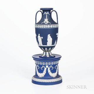 Wedgwood Dark Blue Jasper Dip Vase and Drum Base, England, 19th and 20th century, each with applied white relief, the vase with classical figures belo