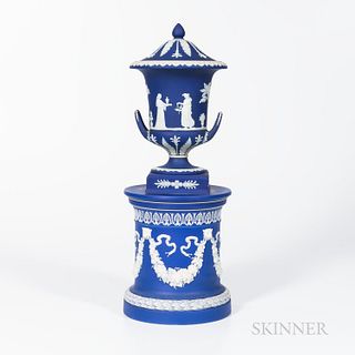 Wedgwood Dark Blue Jasper Dip Covered Vase on Drum Base, England, 19th and 20th century, applied white classical relief, the vase with figures within 