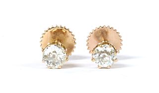 A pair of gold single stone diamond stud earrings,