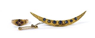 A gold sapphire set crescent brooch,