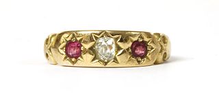 A gold diamond and ruby three stone ring,