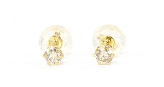 A pair of gold single stone diamond stud earrings,