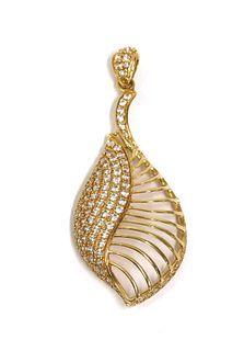 A gold cubic zirconia set shell or leaf form pendant,