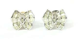 A pair of white gold diamond earrings,