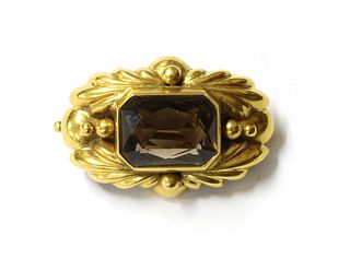 A gold smoky quartz brooch,