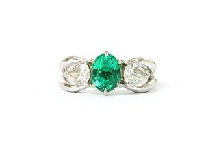 A white gold emerald and diamond three stone ring,