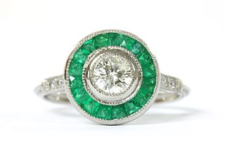 A platinum diamond and emerald target cluster ring,