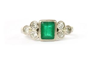 An 18ct white gold emerald and diamond ring,