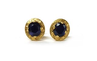 A pair of 14ct gold single stone sapphire stud earrings,