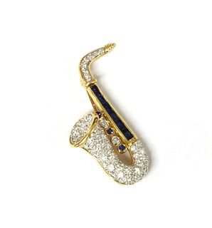 A gold sapphire and diamond novelty saxophone brooch,