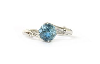 An 18ct white gold aquamarine and diamond crossover ring,