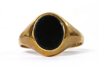 A 9ct gold onyx signet ring.