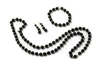 An onyx and gold bead necklace, bracelet and earrings suite,