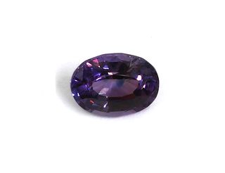 An unmounted oval mixed cut purple sapphire,