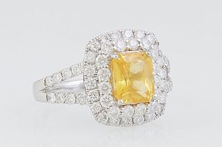 Lady's Platinum Dinner Ring, with a 2.09 carat octagonal yellow sapphire atop a double graduated concentric border of round diamonds, the split should