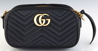 Gucci Crossbody Bag, in black calf leather with chevron stitching and golden hardware, opening to a tan suede lined interior with a side open storage 