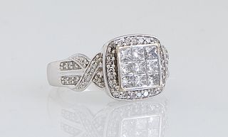 Lady's 14K White Gold Dinner Ring, the center with a raised square of nine princess cut diamonds, within a border of round diamonds, the twisted shoul