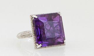 Lady's 14K White Gold Dinner Ring, with a square 30.21 carat amethyst, atop a border of tiny round diamonds, the pierced sides of the basket mounted w