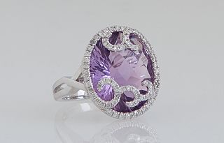 Lady's 14K White Gold Dinner Ring, with an oval 11.5 carat amethyst, within a swirled border of tiny round diamonds, Total Diamond Wt.- .49 cts., Size